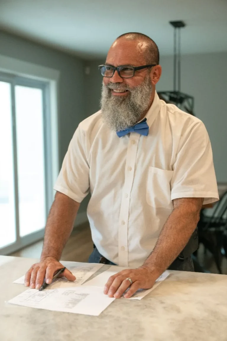 Mulberry Service Co. plumber reviewing plans at a kitchen counter